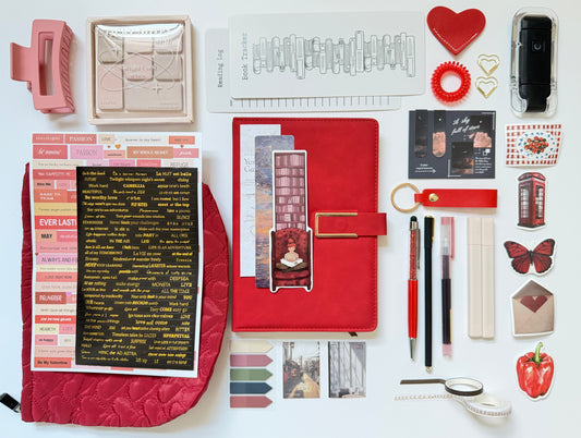 Red stationery gift box with notebook, pens and desk accessories